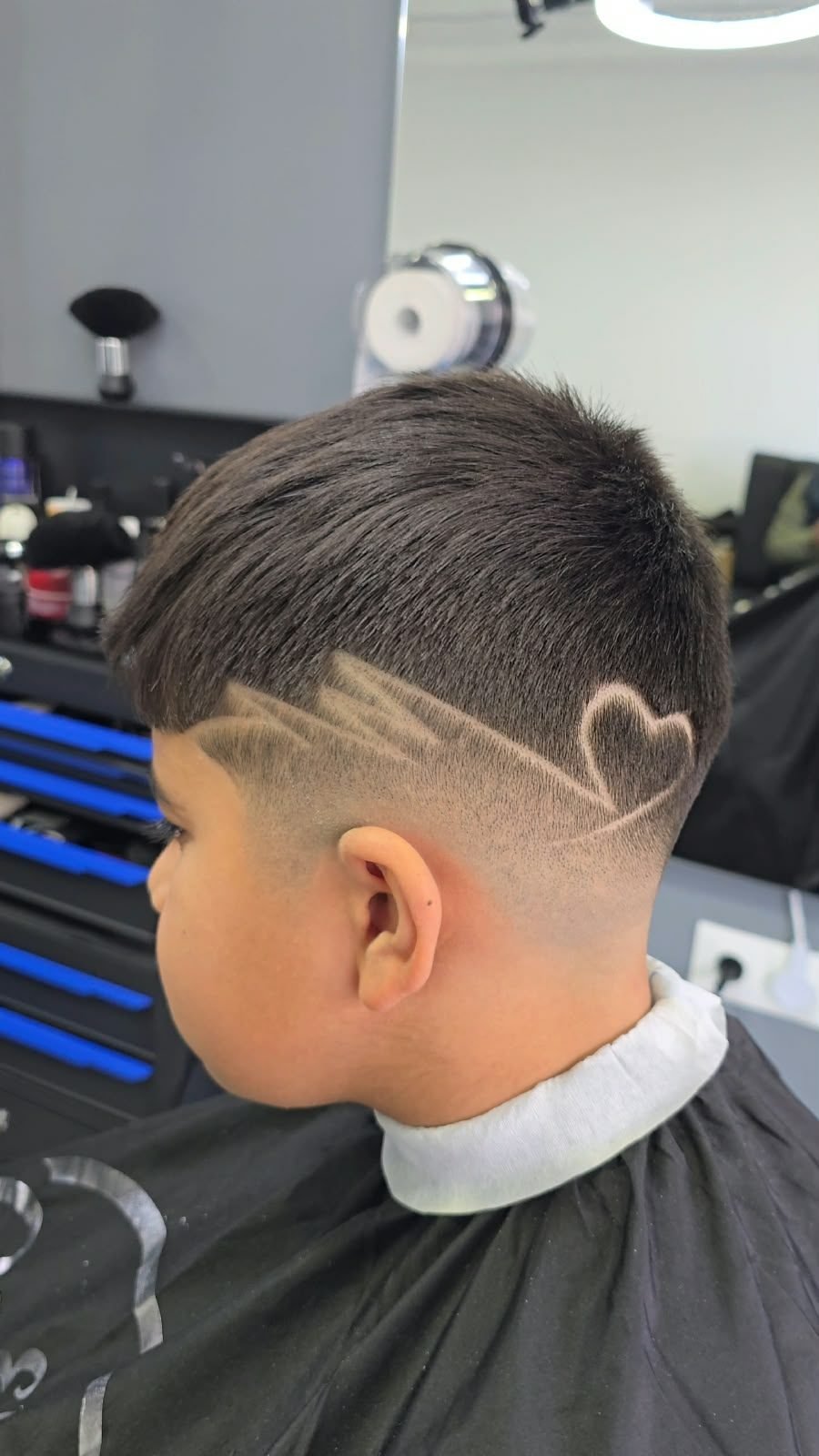 Corte infantil con un corazón dibujado a navaja en El Panita Barbershop